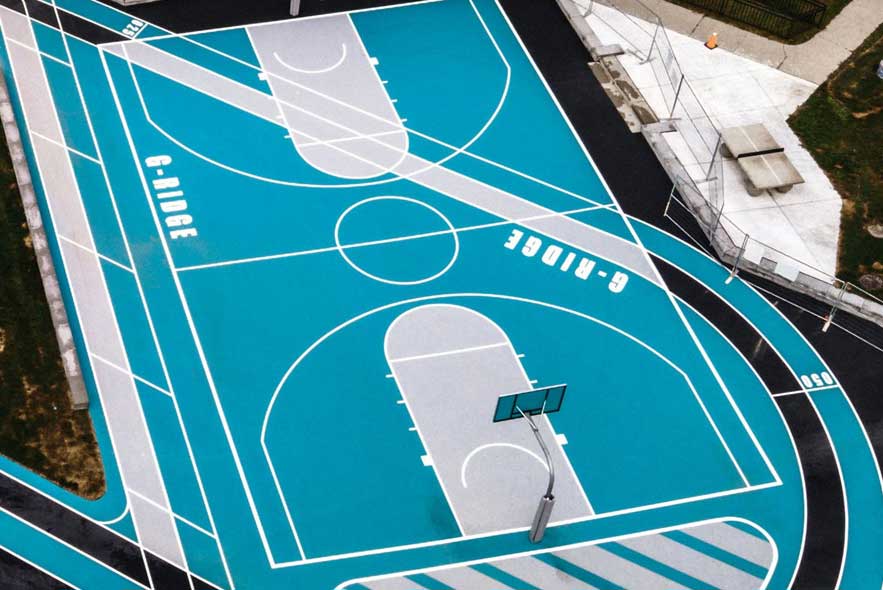 Aerial view of a basketball court featuring a blue and white design, showcasing the court's layout and markings.