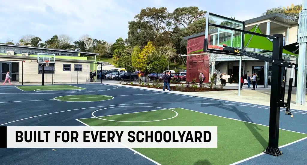 Outdoor basketball court setup at a school with durable hoops.