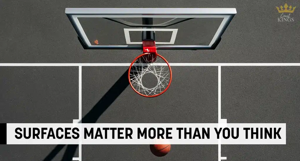 Top view of basketball hoop and ball on clean blacktop surface.